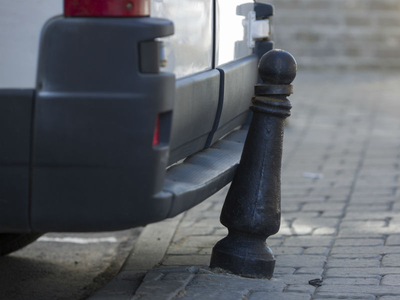 Van reversing into a post