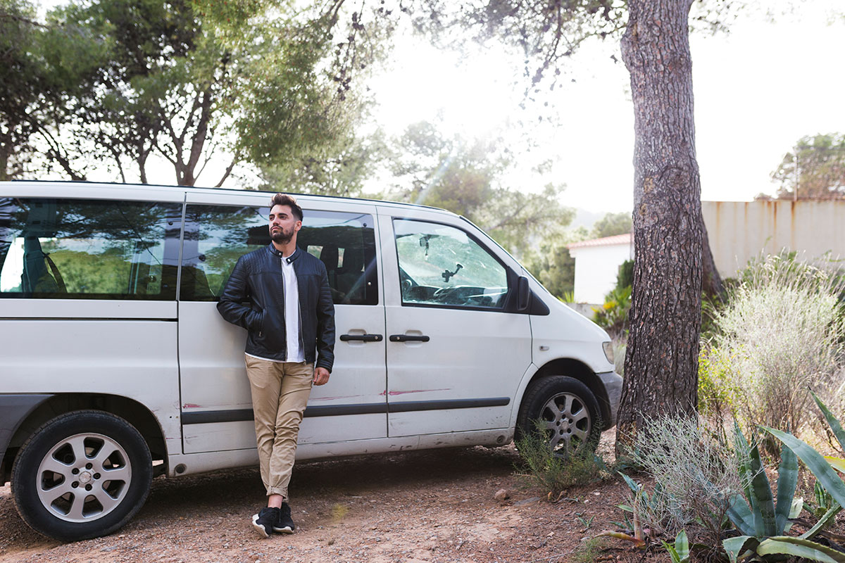 man leaning front car